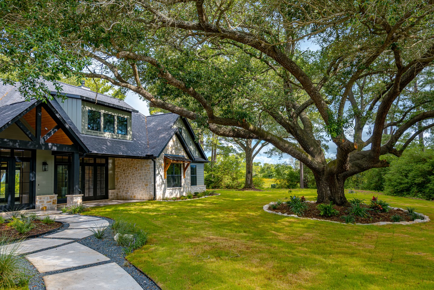 House with large tree and lawn